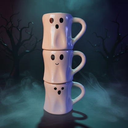 Three white mugs with ghost faces stacked on a white background
