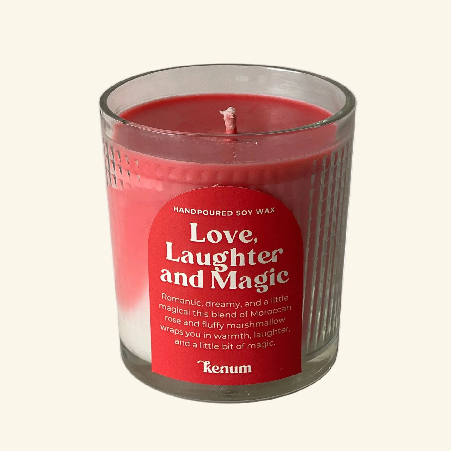 Candle in a glass jar with a red label on a white background