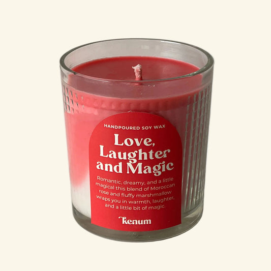 Candle in a glass jar with a red label on a white background